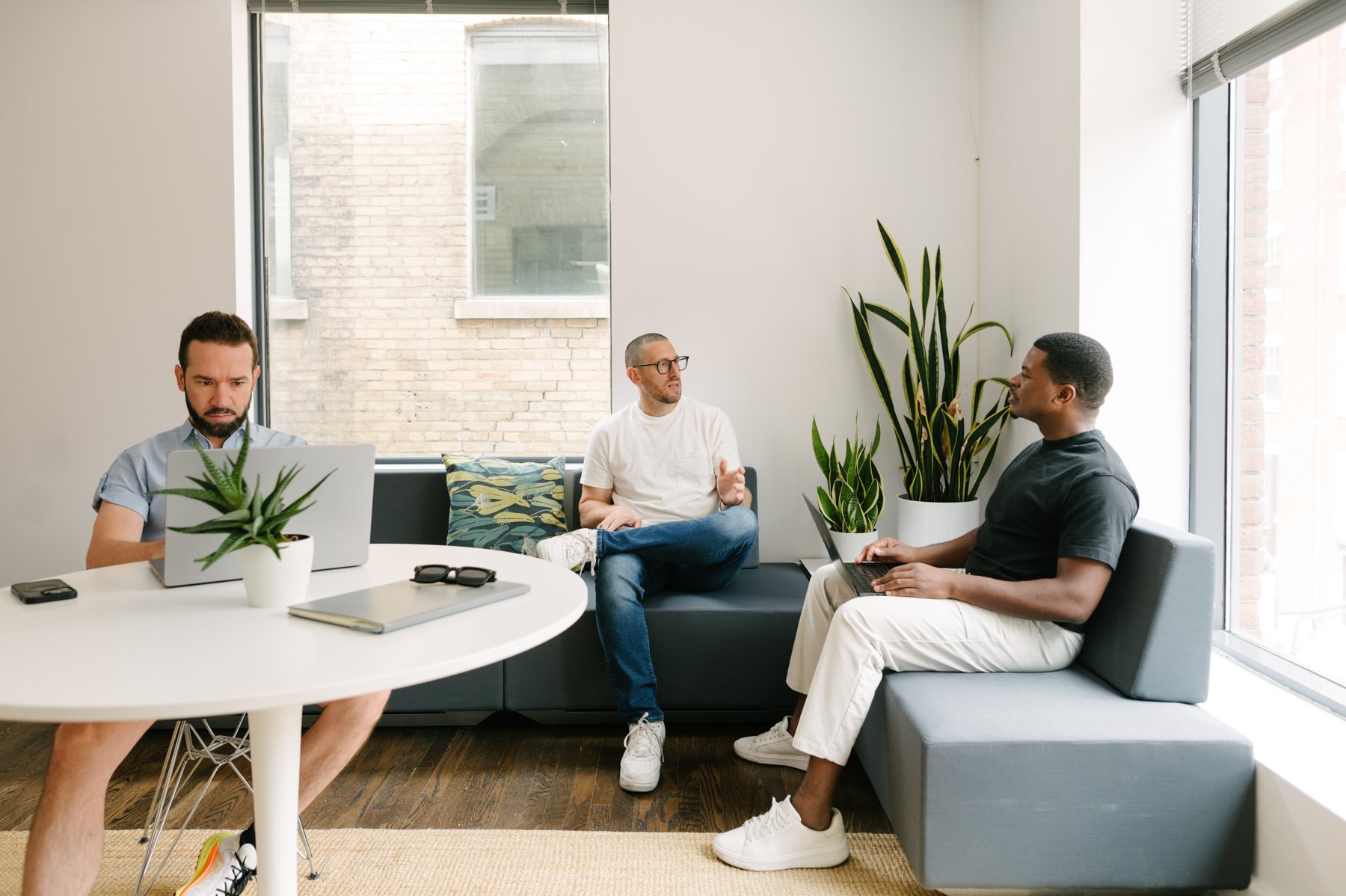Jason and two founders talking in a bright studio