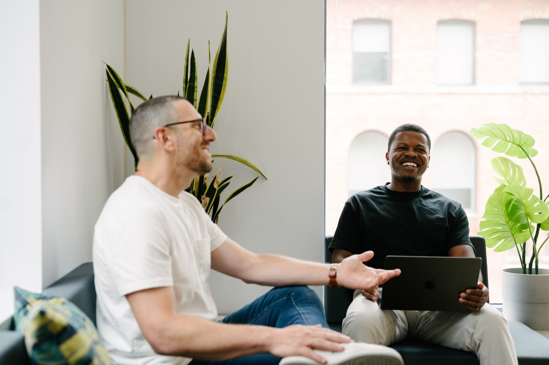 Jason Goodman laughing with a founder in a working session