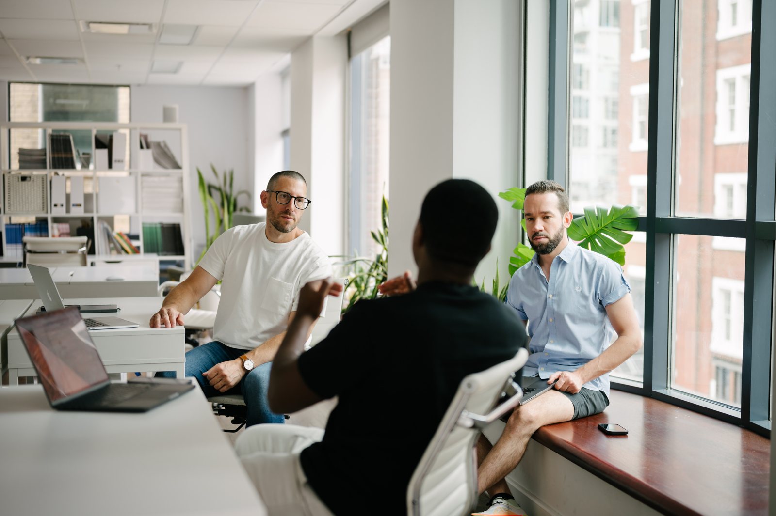 Jason Goodman working with founders at a desk by the window
